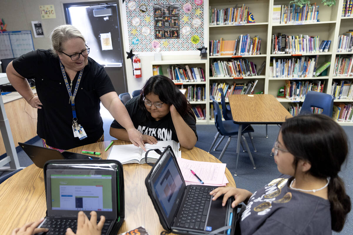 Tutor Kim Roden, who teaches English at Moapa Valley High School, helps junior Aiyana Jim with ...