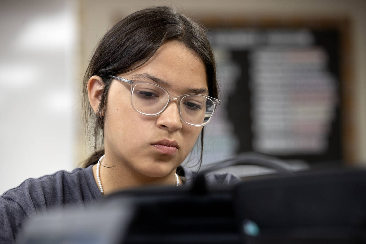 Eighth grader Shloe Anderson concentrates on her homework at the Moapa Educational Support Cent ...