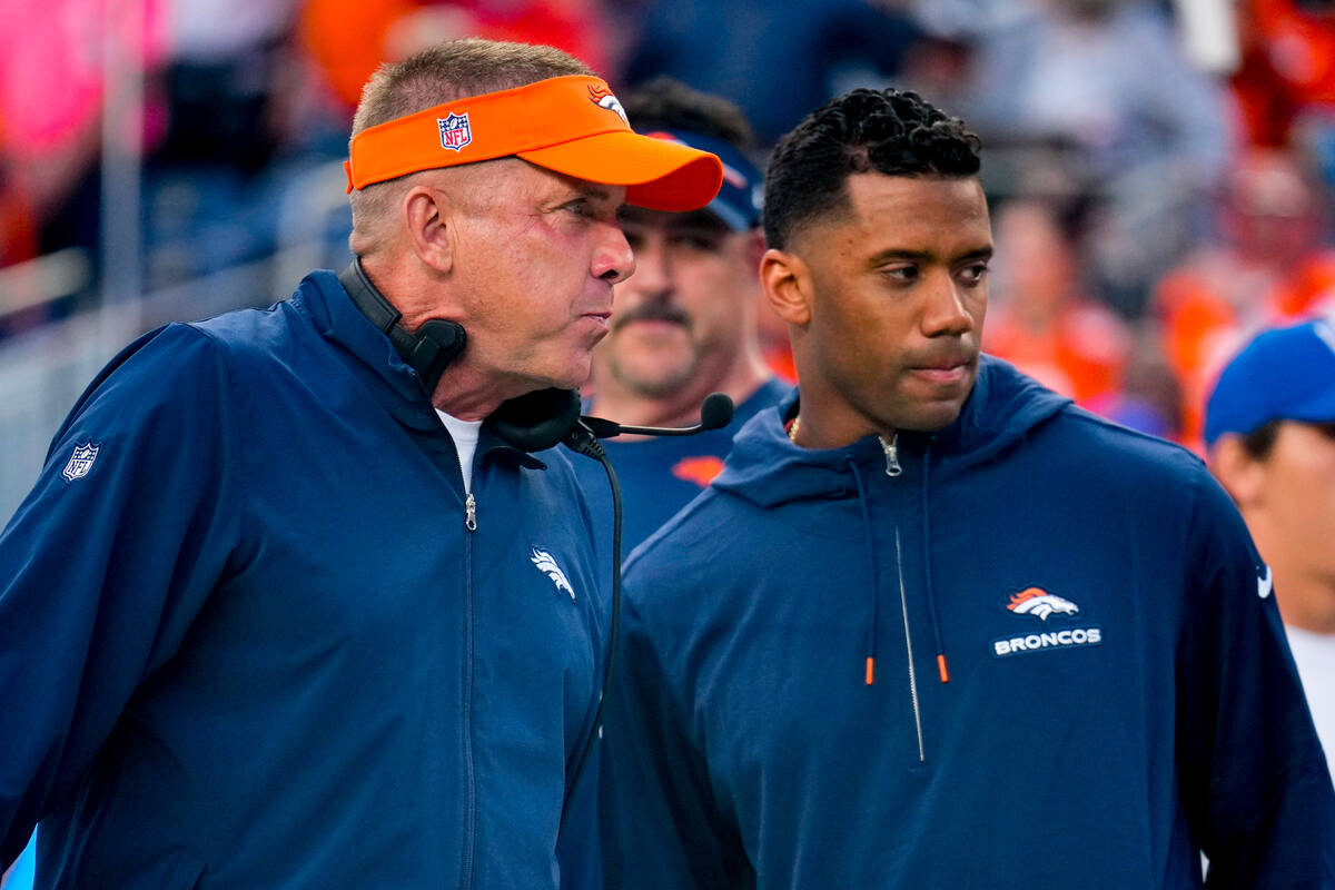 Denver Broncos head coach Sean Payton talks with Denver Broncos quarterback Russell Wilson (3) ...