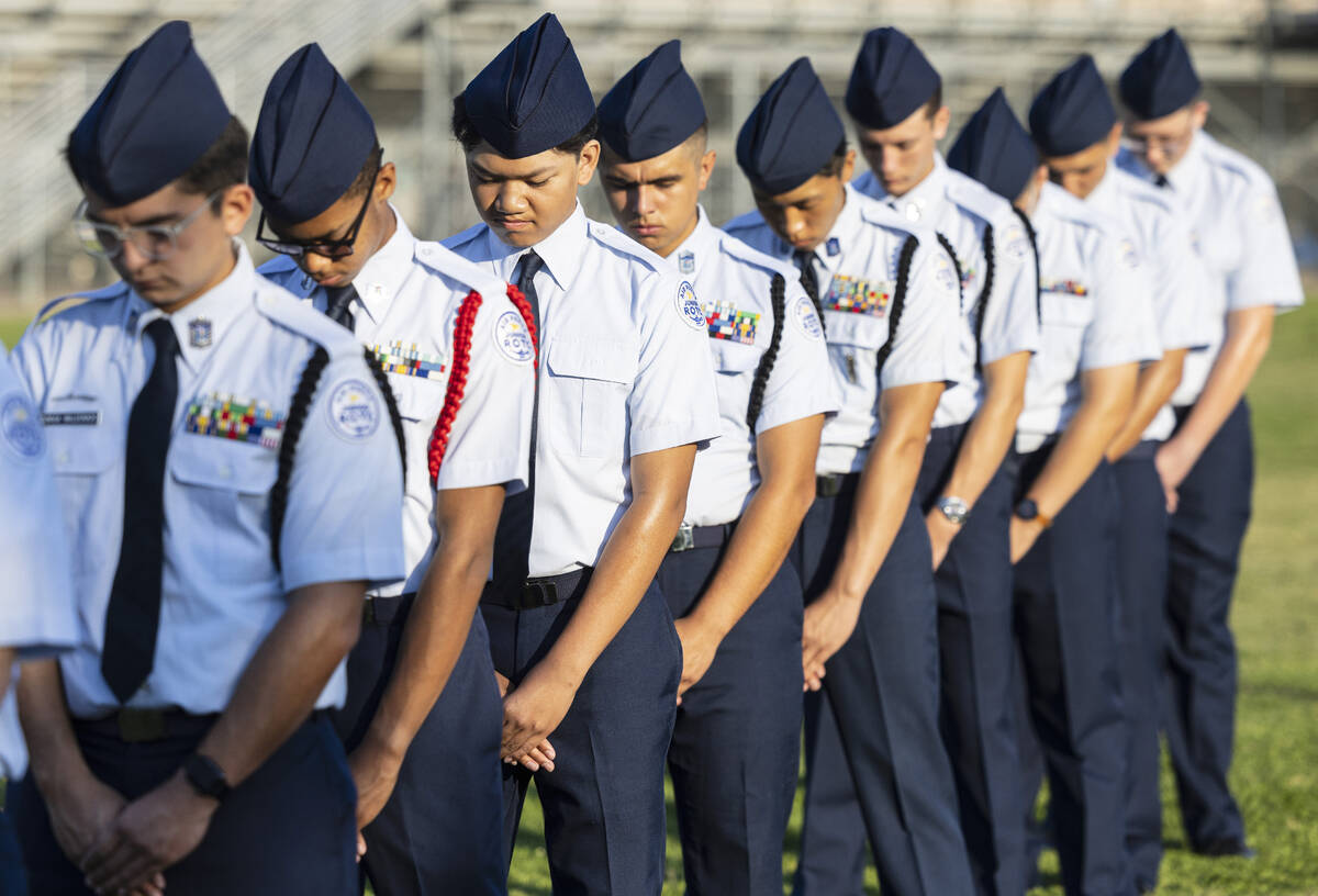 Members of the Palo Verde High School Air Force Junior ROTC bow their heads in a moment of sile ...