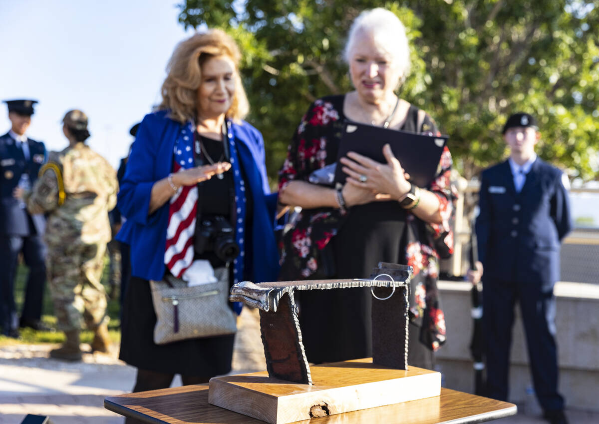 Cathy Navin, left, and Gail Fahy look at a piece of steel that was recovered from the Pentagon, ...