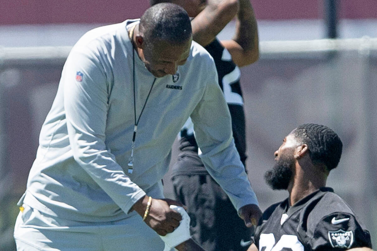 Raiders defensive coordinator Patrick Graham greets cornerback Nate Hobbs (39) with a handshake ...