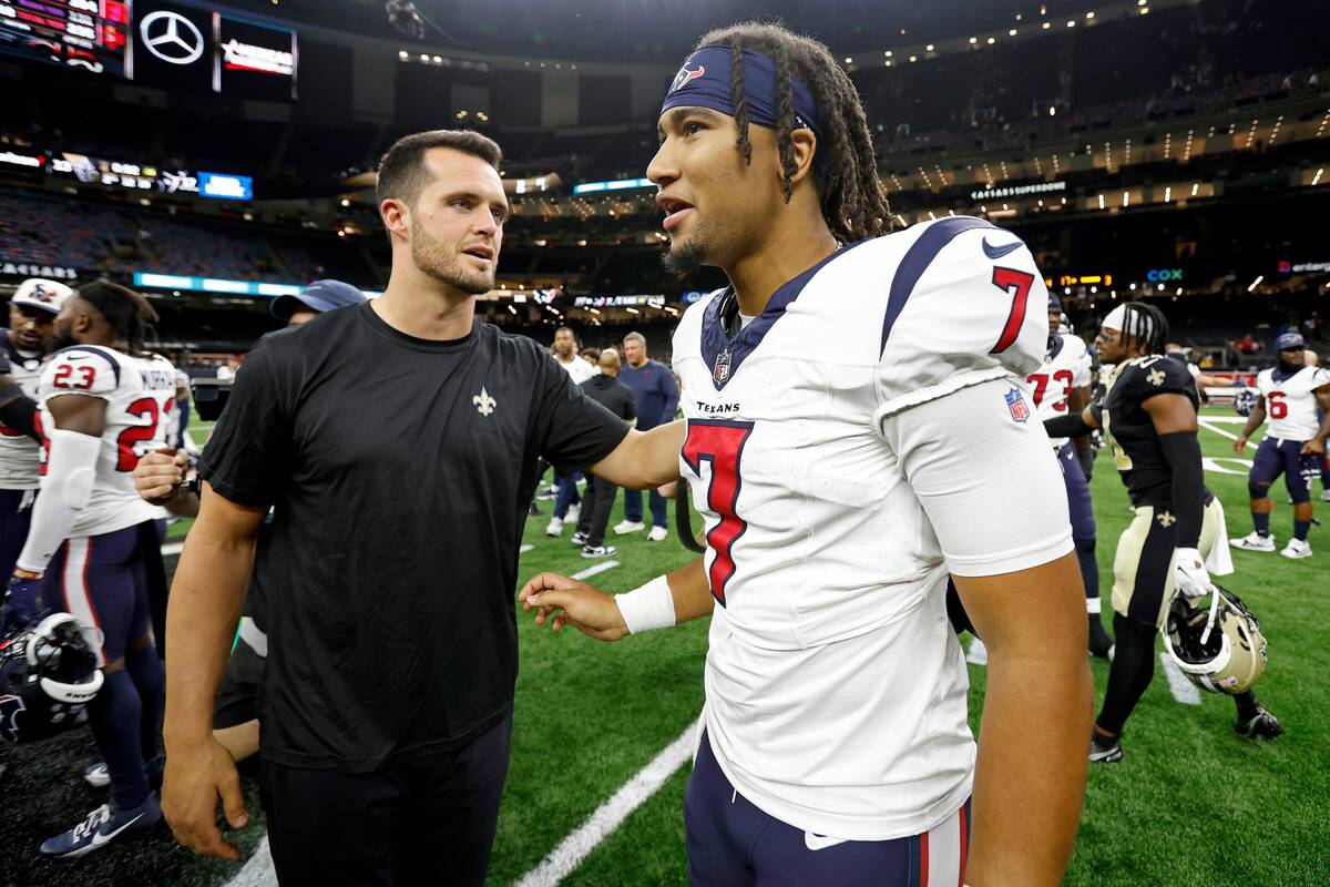 Houston Texans quarterback C.J. Stroud (7) talks with New Orleans Saints quarterback Derek Carr ...