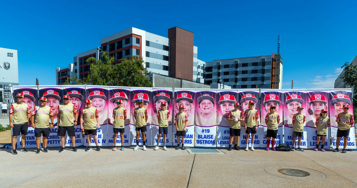 The Henderson Little League team and coaches pose with their portrait banners at City Hall duri ...
