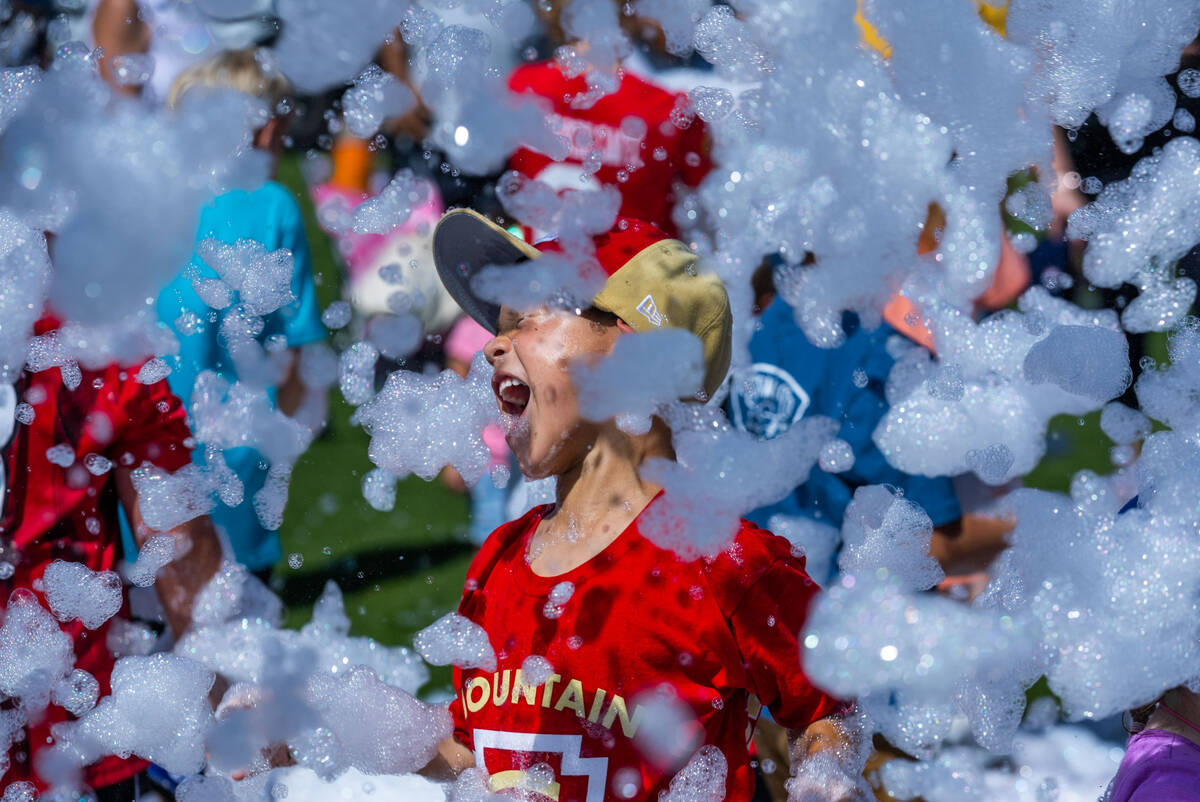 A young fan is excited about bubbles pumped into the air during a celebration for the Henderso ...