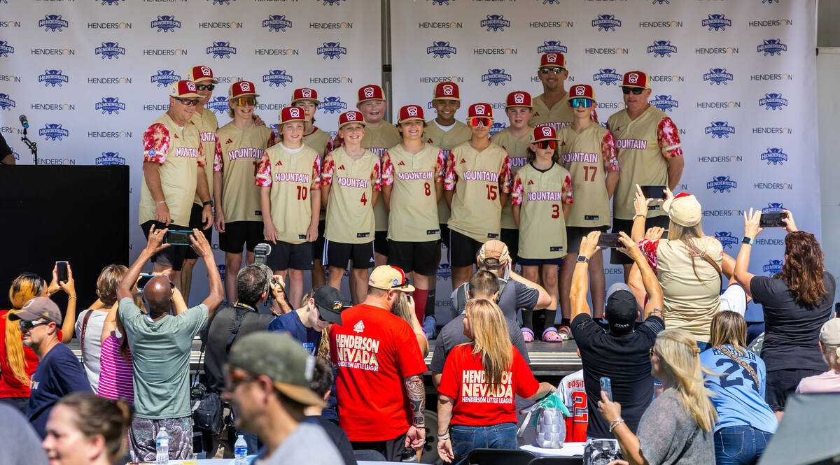 Henderson Little League team players and coaches gather on stage for a group shot during a cele ...