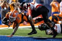 Bishop Gorman Devon Rice (3) dives into the end zone to score while under pressure from Centenn ...