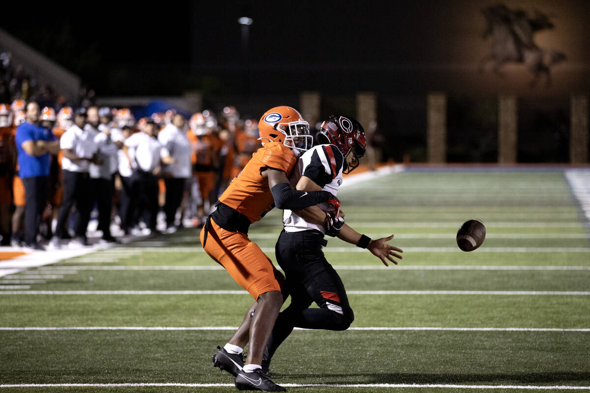 Bishop Gorman's Jett Washington (5) stops Centennial quarterback Husan Longstreet (4) from catc ...