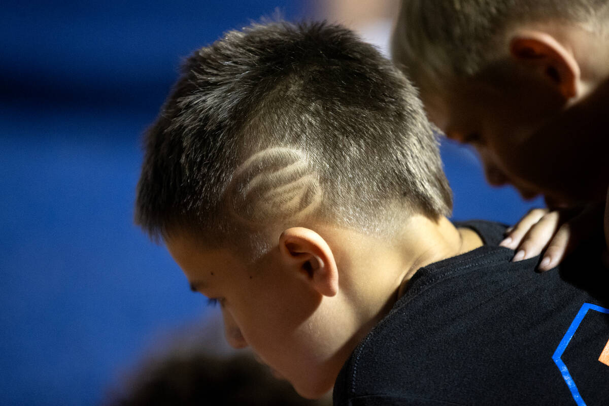 A young Bishop Gorman fan has the Gaels’ logo shaved into his hair during a high school ...