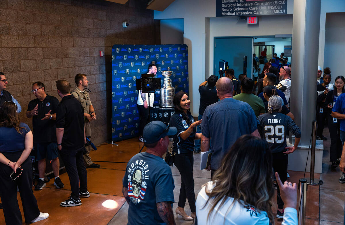 UMC Hospital workers line up about the hall waiting for their moment with the Stanley Cup durin ...
