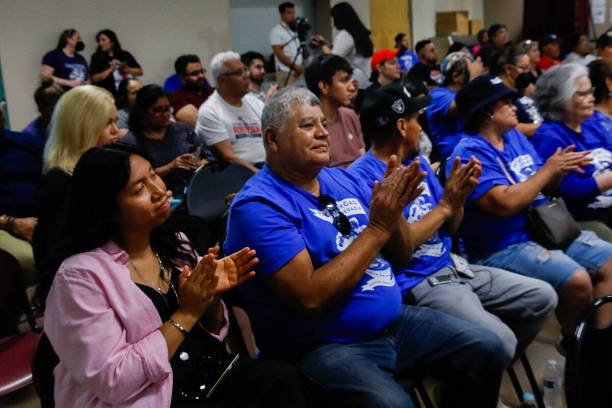 Marina Bahena, left, and Manuel Cazares, second left, along with other members of Make The Road ...