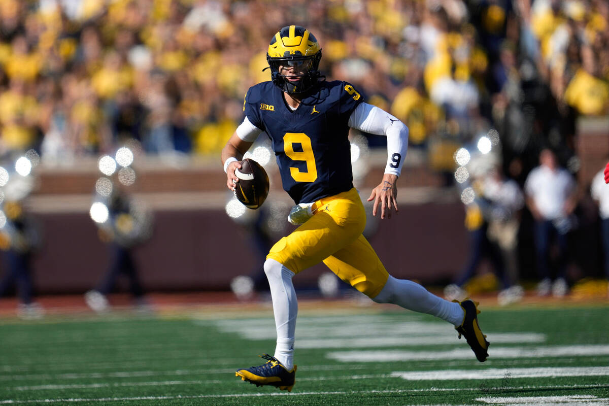 Michigan quarterback J.J. McCarthy (9) looks to throw against UNLV in the first half of an NCAA ...