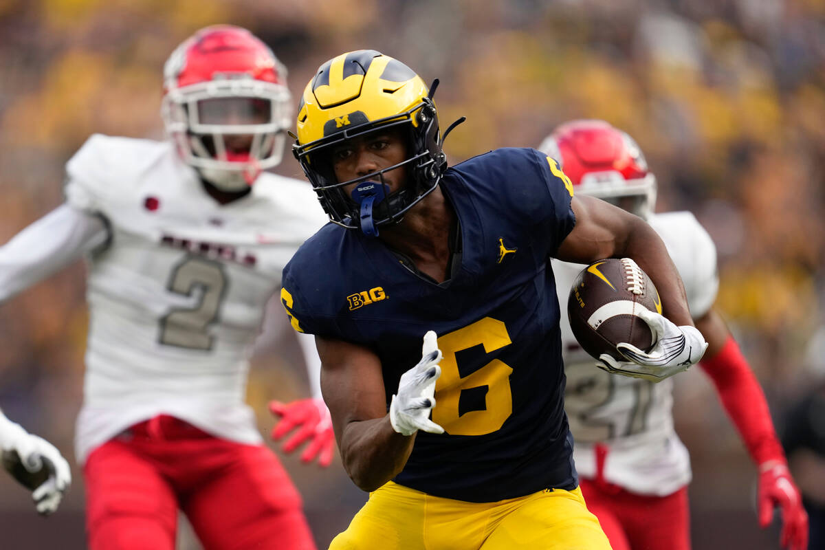 Michigan wide receiver Cornelius Johnson (6) runs after a catch against the UNLV in the second ...