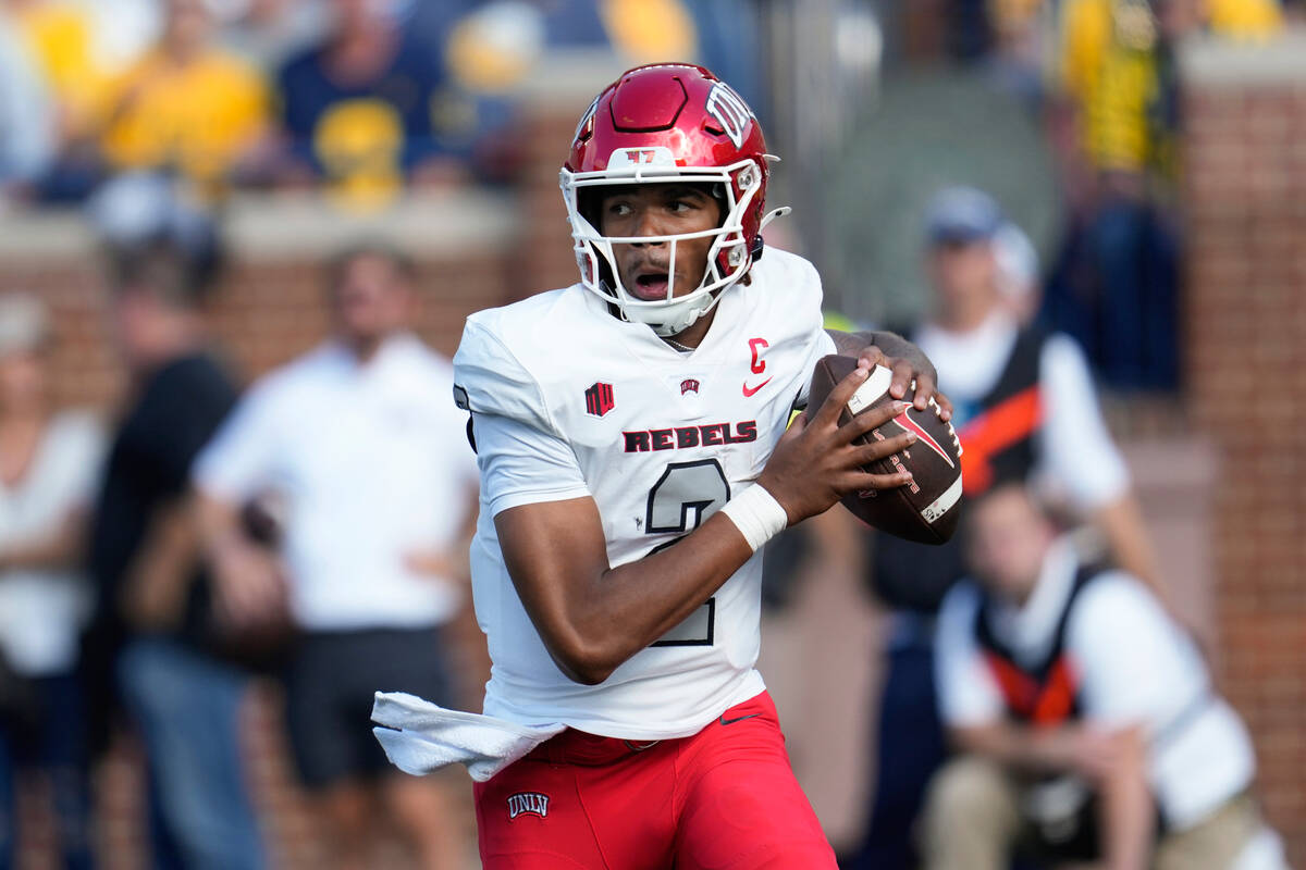 UNLV quarterback Doug Brumfield (2) looks to throw against Michigan in the first half of an NCA ...