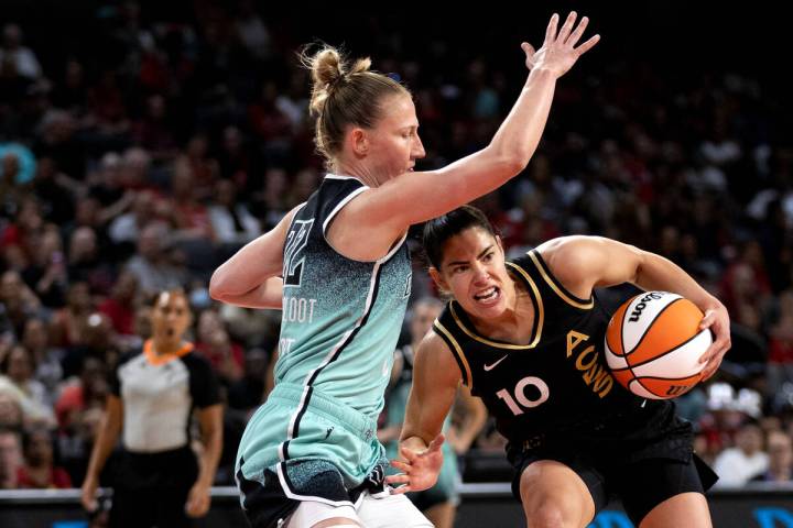 Las Vegas Aces guard Kelsey Plum (10) dribbles around New York Liberty guard Courtney Vanderslo ...
