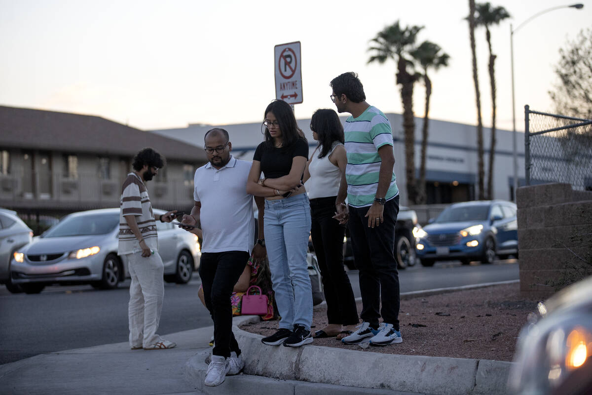 Concertgoers wait for ride shares near Allegiant Stadium after Ed Sheeran canceled his concert ...