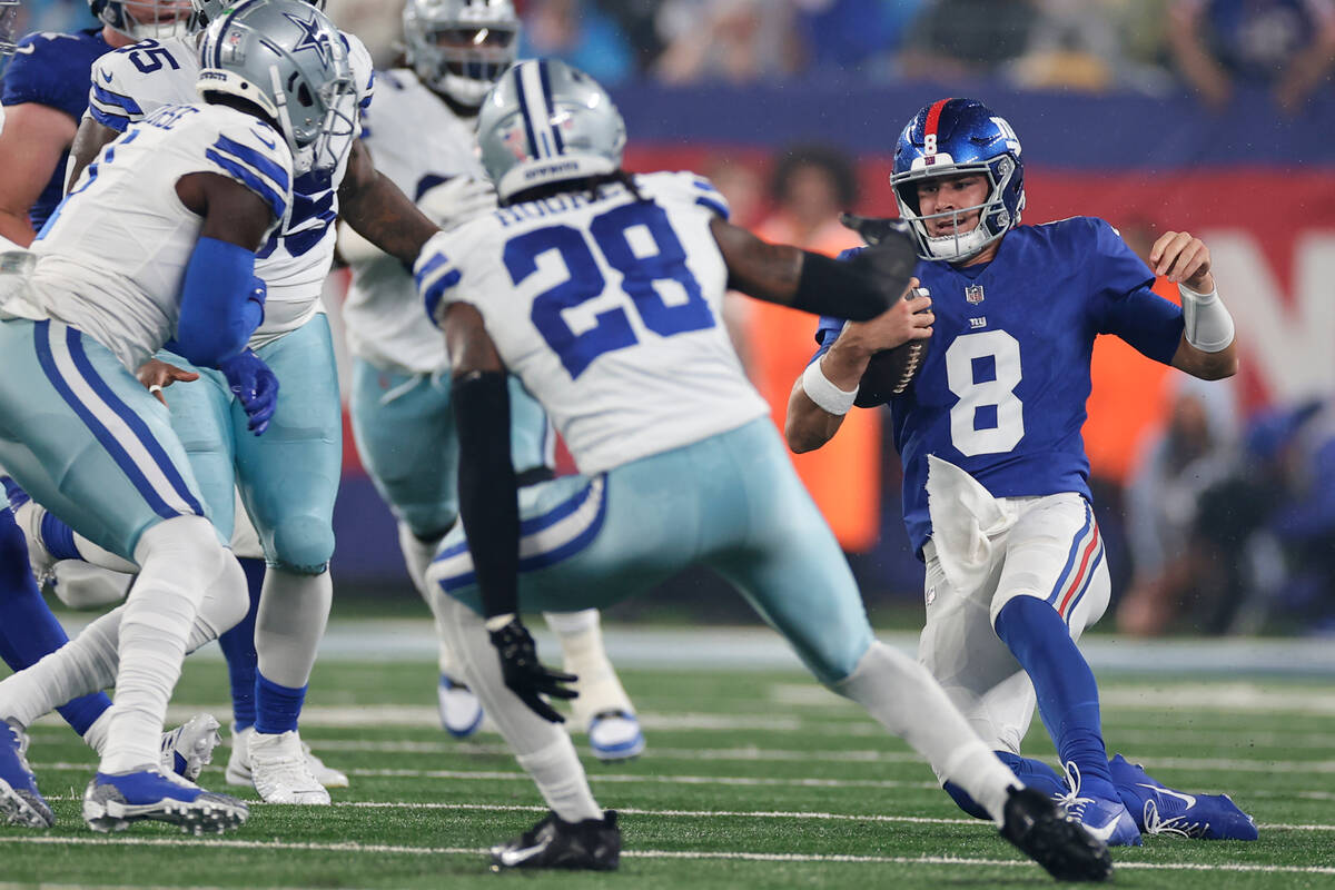 New York Giants' Daniel Jones slides during the first half of an NFL football game against the ...