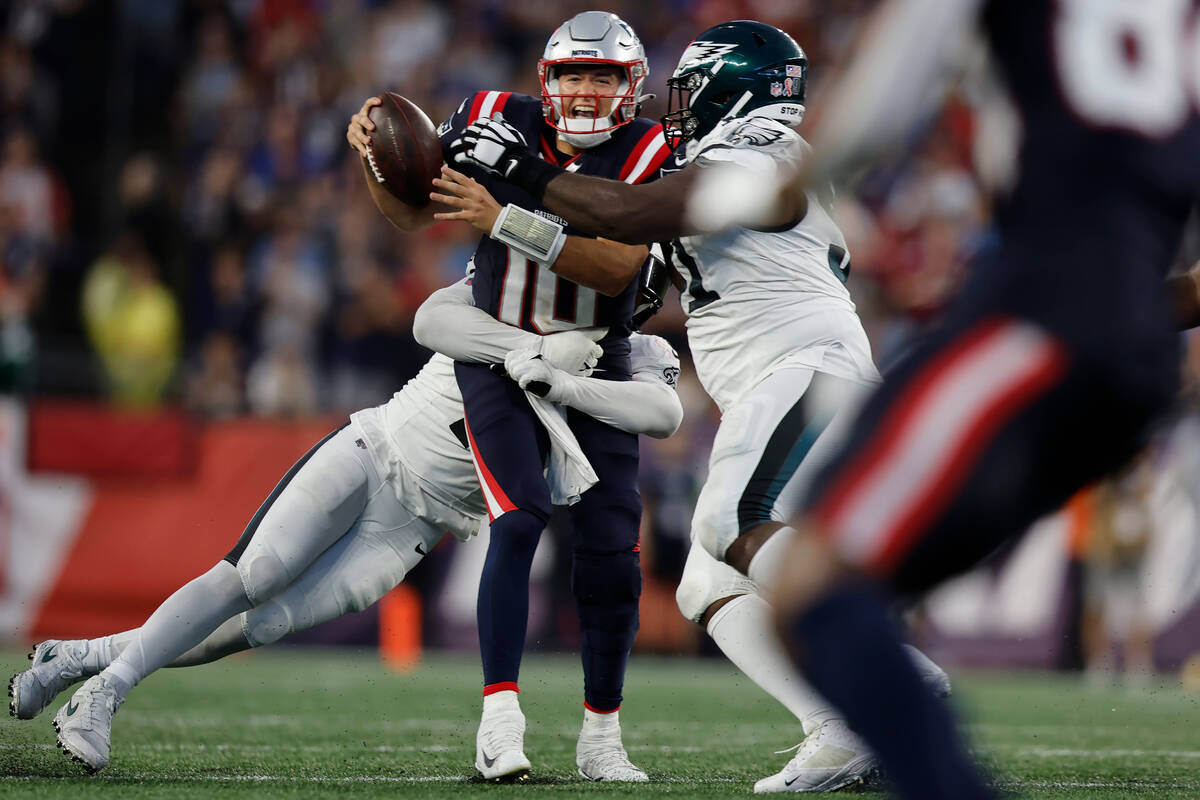 New England Patriots quarterback Mac Jones (10) is brought down by Philadelphia Eagles lineback ...