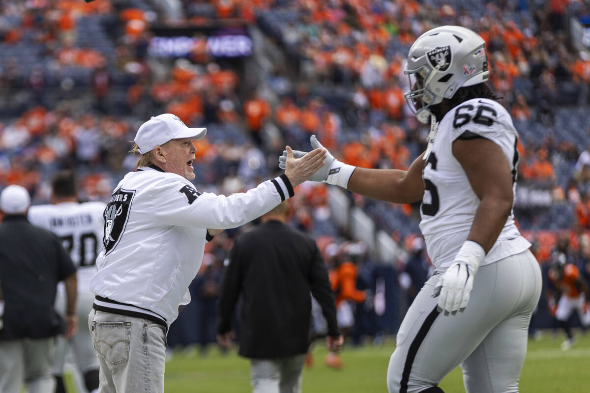 Raiders owner Mark Davis greets guard Dylan Parham (66) before the start of an NFL game against ...