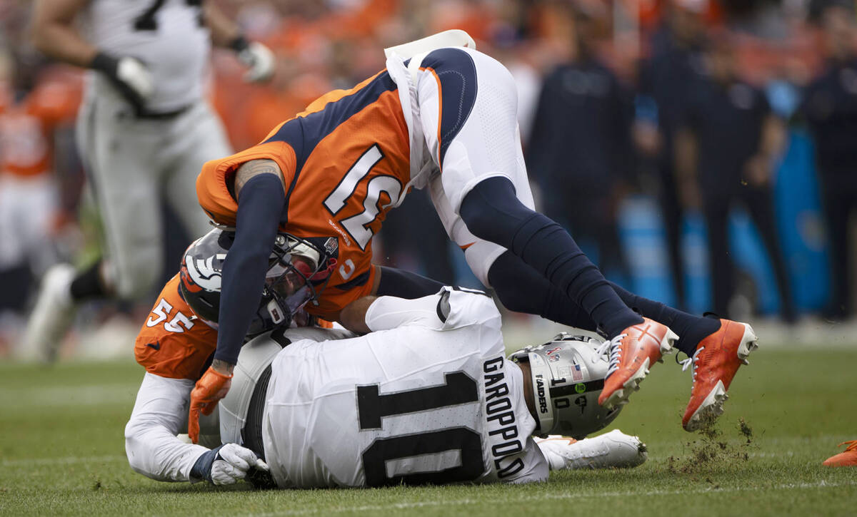 Raiders quarterback Jimmy Garoppolo (10) is tackled by Denver Broncos linebacker Frank Clark (5 ...