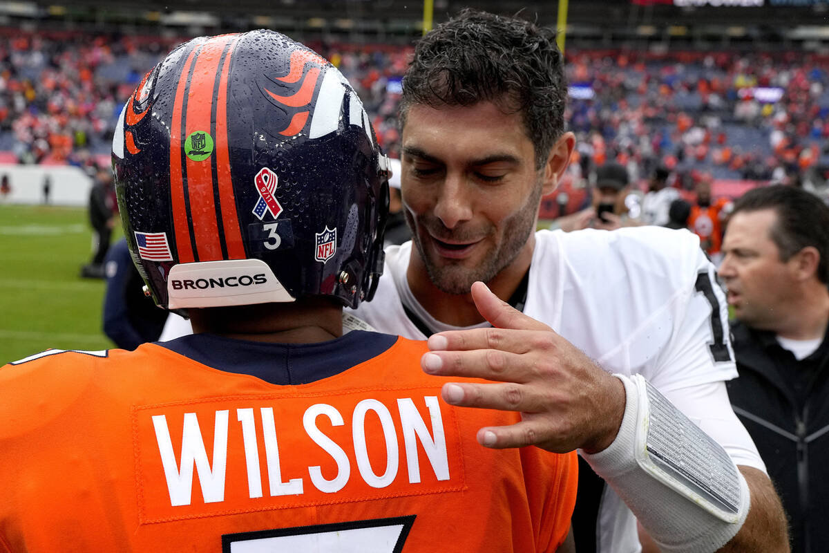 Denver Broncos quarterback Russell Wilson (3) greets Las Vegas Raiders quarterback Jimmy Garopp ...