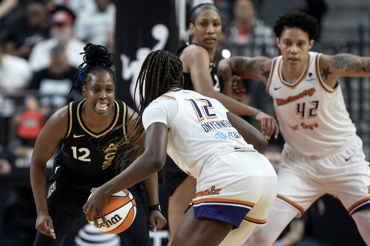 Las Vegas Aces guard Chelsea Gray (12) defends against Phoenix Mercury forward Michaela Onyenwe ...
