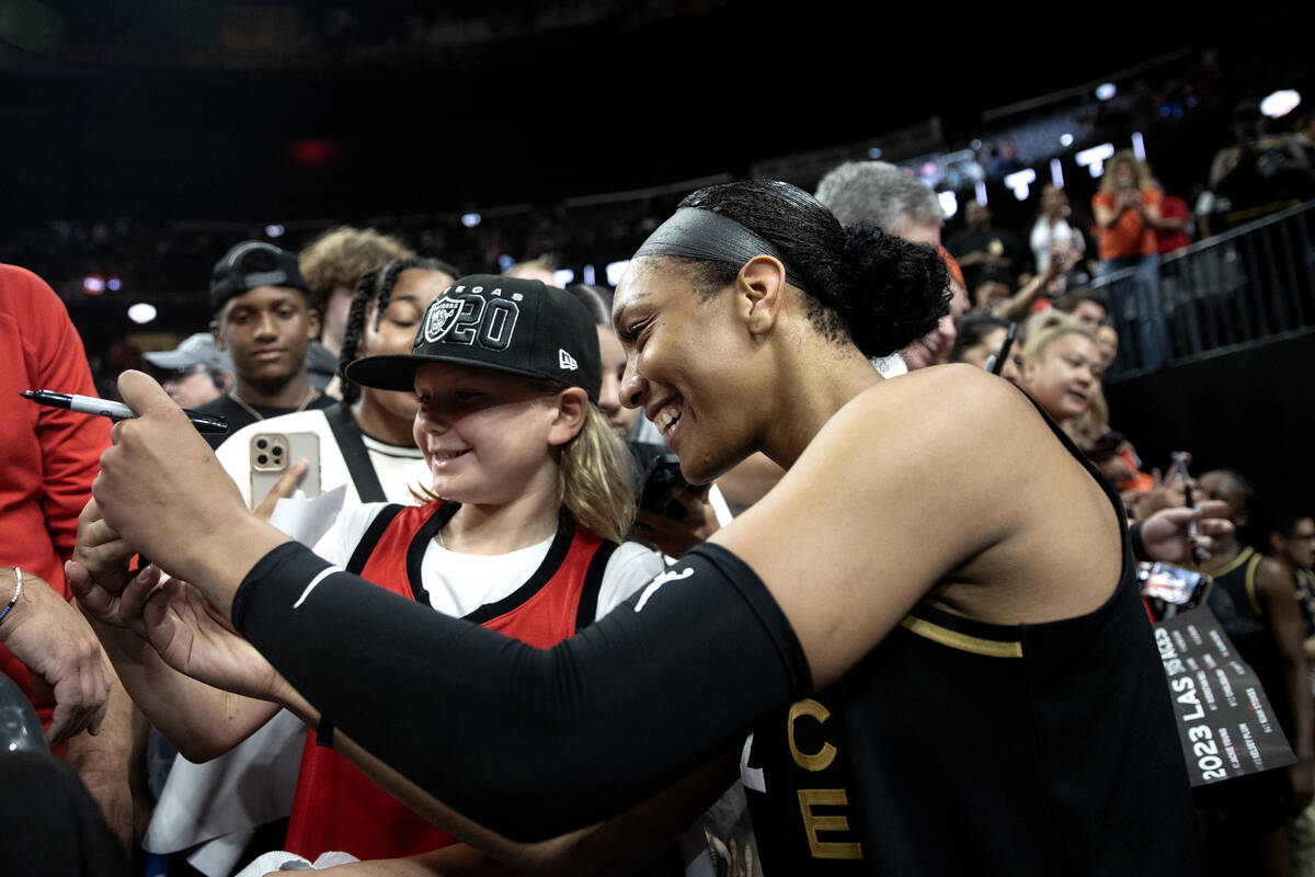 Las Vegas Aces forward A'ja Wilson (22) takes a selfie with a fan after winning a WNBA basketba ...