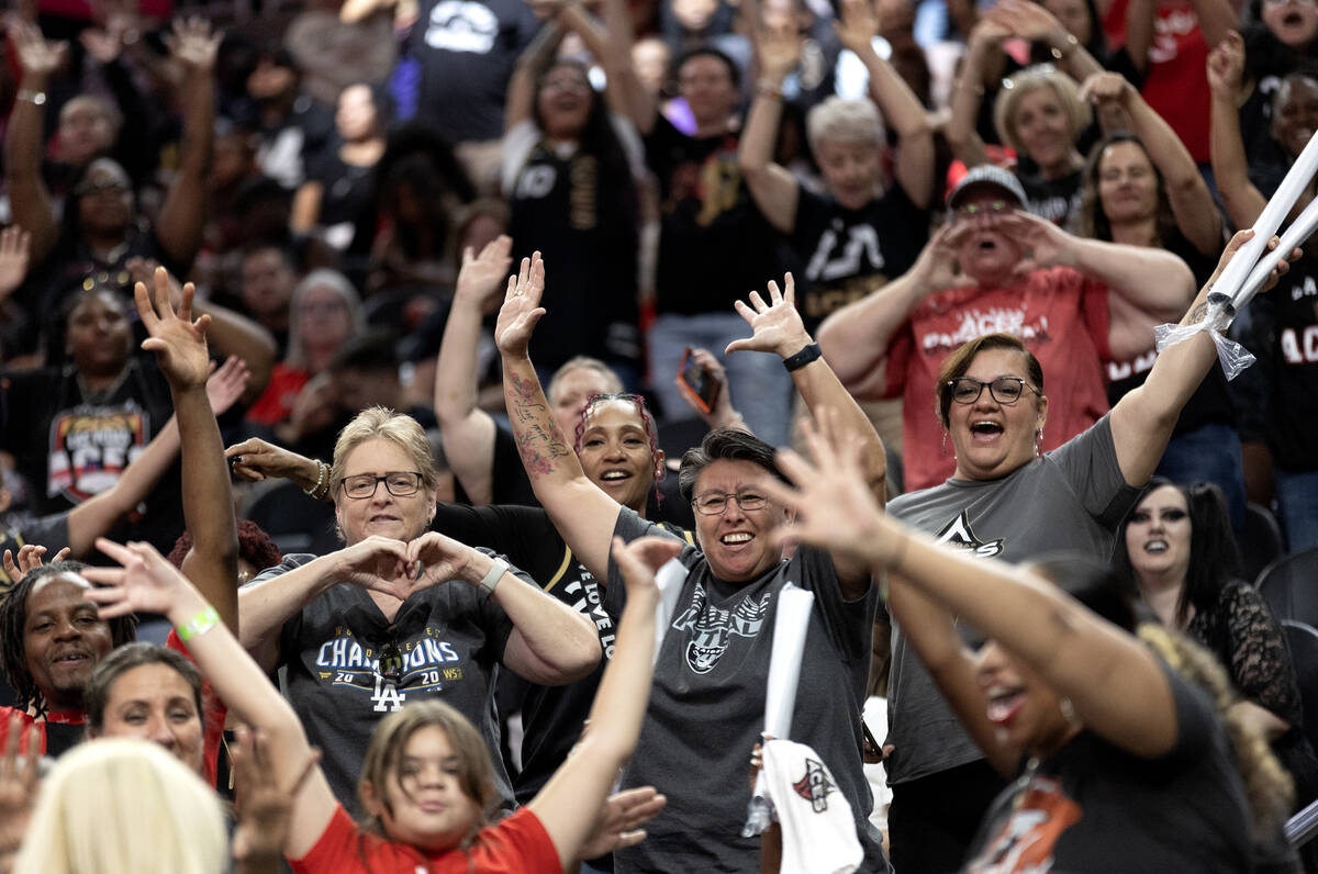 Las Vegas Aces fans cheer while staff passes out signed prizes during the second half of a WNBA ...