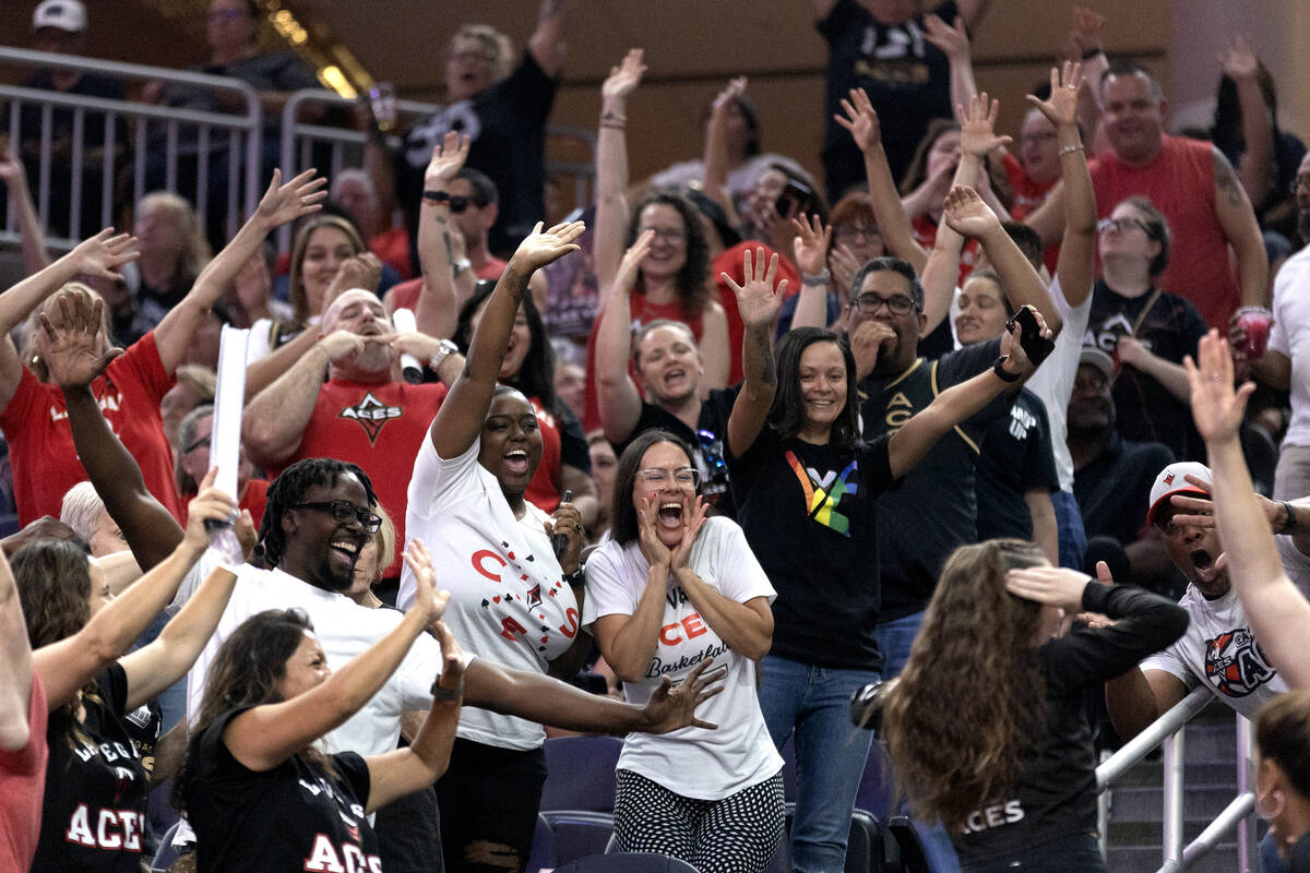 Las Vegas Aces fans scream for t-shirts during the first half of a WNBA basketball game against ...