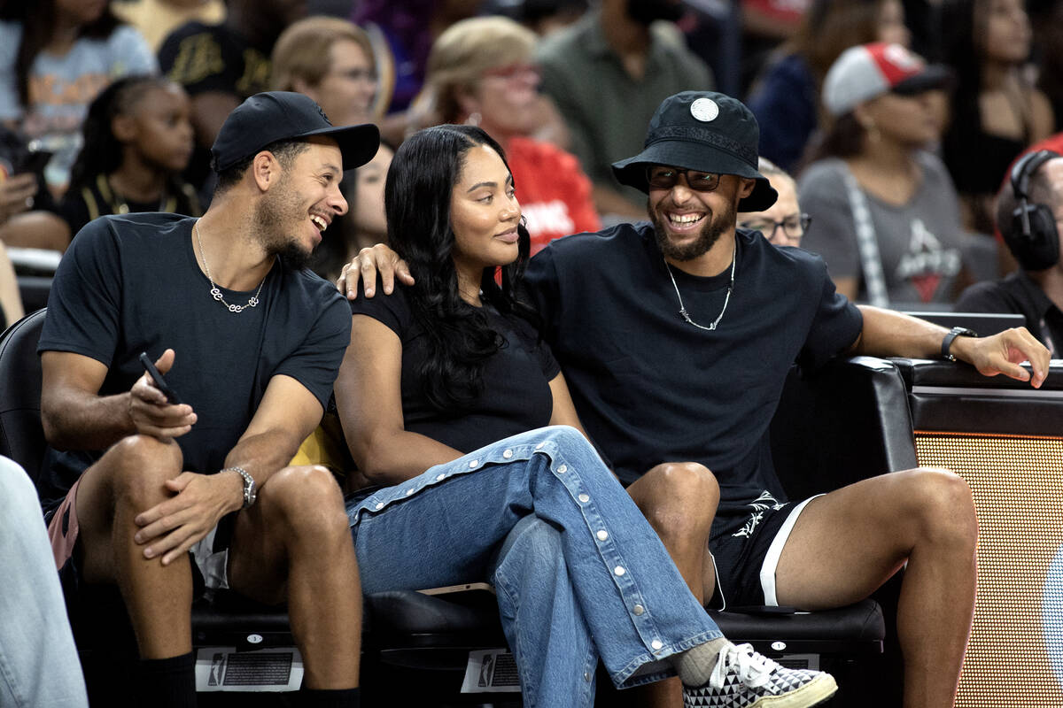 Seth Curry, Ayesha Curry and Stephen Curry attend a WNBA basketball game between the Las Vegas ...