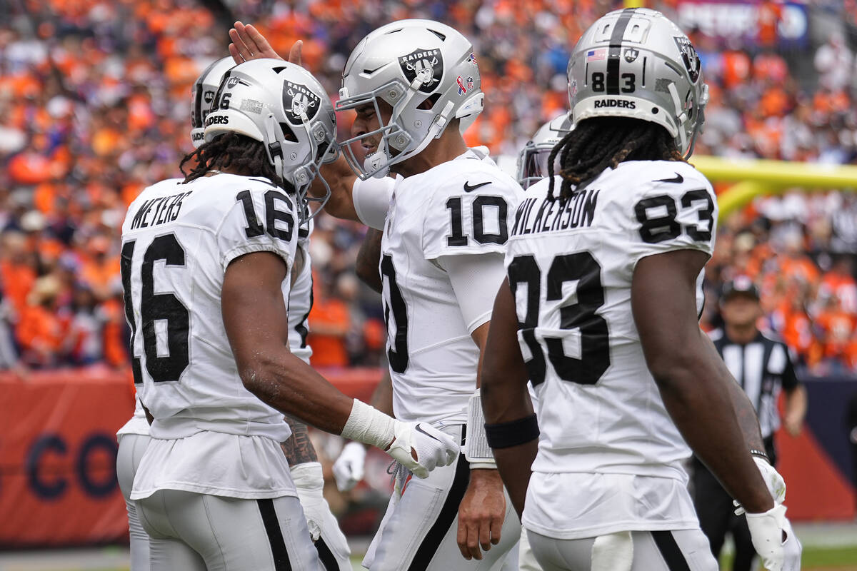 Las Vegas Raiders wide receiver Jakobi Meyers (16) celebrates his touchdown with quarterback Ji ...