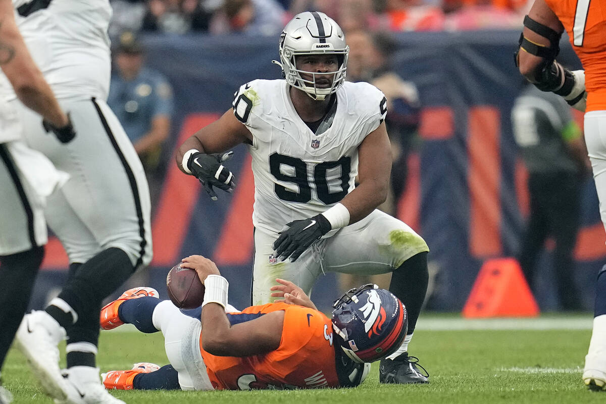 Denver Broncos quarterback Russell Wilson is sacked by Las Vegas Raiders defensive tackle Jerry ...