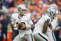 Raiders quarterback Jimmy Garoppolo (10) drops back to throw as Raiders running back Josh Jacob ...