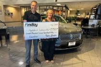 Jeff Giles, marketing director for Findlay Automotive, presents a check to Stacey Lockhart, CEO ...