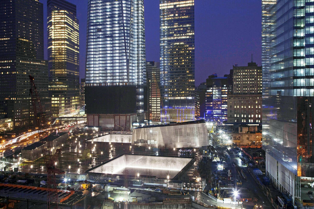 FILE — The twin reflecting pools, center, of the National September 11 Memorial are illu ...