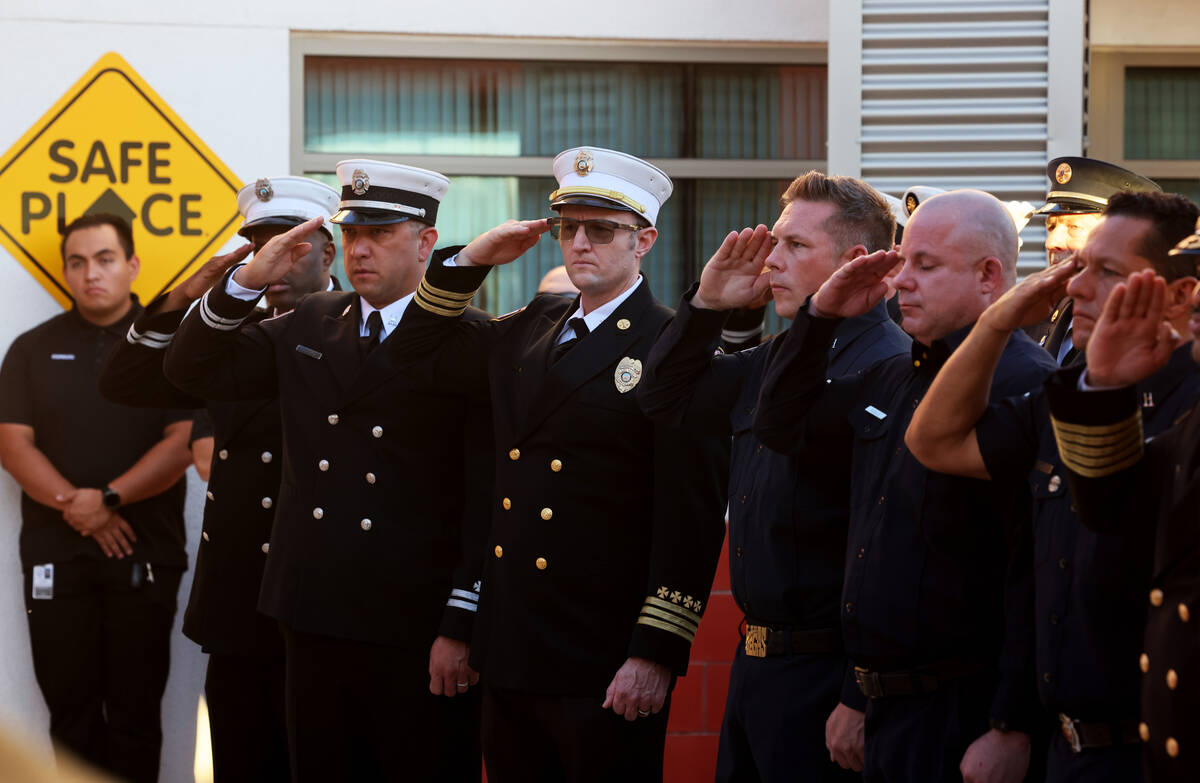 Las Vegas Firefighters salute as an American flag that flew over the World Trade Center in New ...