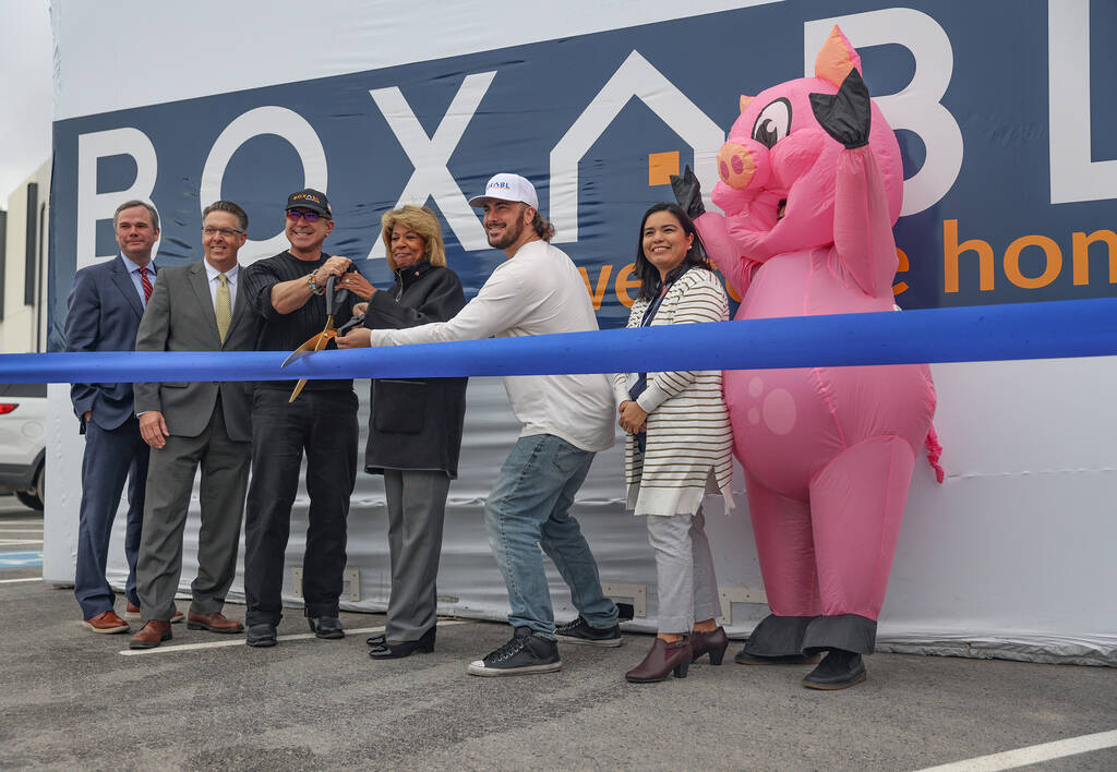 Paulo Tiramani, CEO of Boxabl, left, holds scissors with North Las Vegas Mayor Pamela Goynes-Br ...