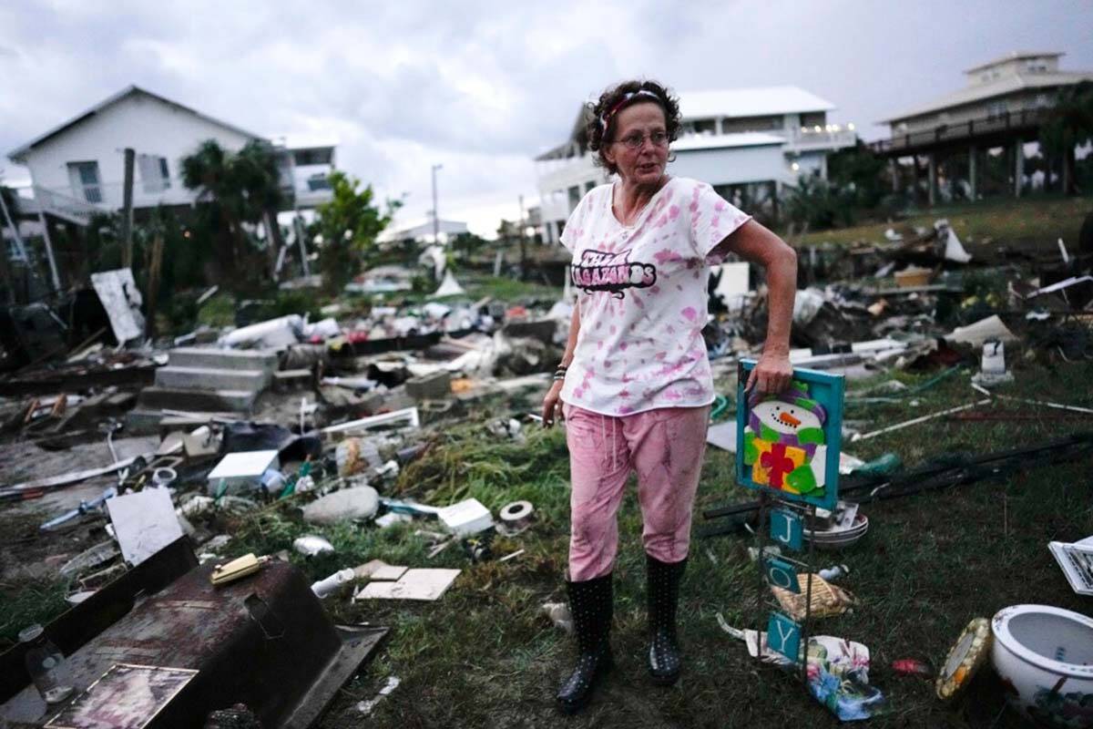 Jewell Baggett stands beside a Christmas decoration she recovered from the wreckage of her moth ...