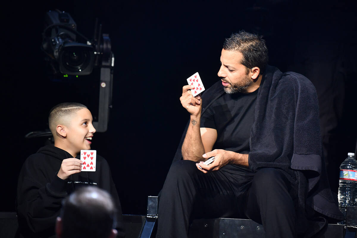 David Blaine and a young audience member are shown on opening night of "In Spades" show at The ...
