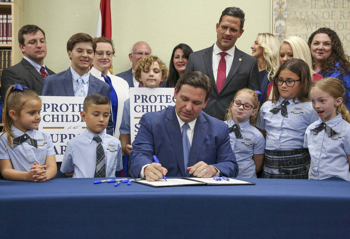 FILE - Florida Gov. Ron DeSantis signs the Parental Rights in Education bill at Classical Prepa ...