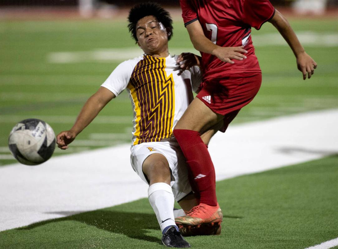 Eldorado's Abraham Chavez (1) slide tackles Arbor View's Bryce Rocha (7) during a boys high sch ...