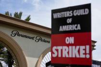FILE - Members of the The Writers Guild of America picket outside Paramount Pictures on May 3, ...
