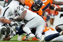 Las Vegas Raiders running back Josh Jacobs (8) is tackled by Denver Broncos linebacker Jonathon ...