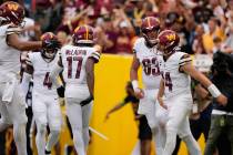 Washington Commanders quarterback Sam Howell (14) celebrates running in for a touchdown with te ...
