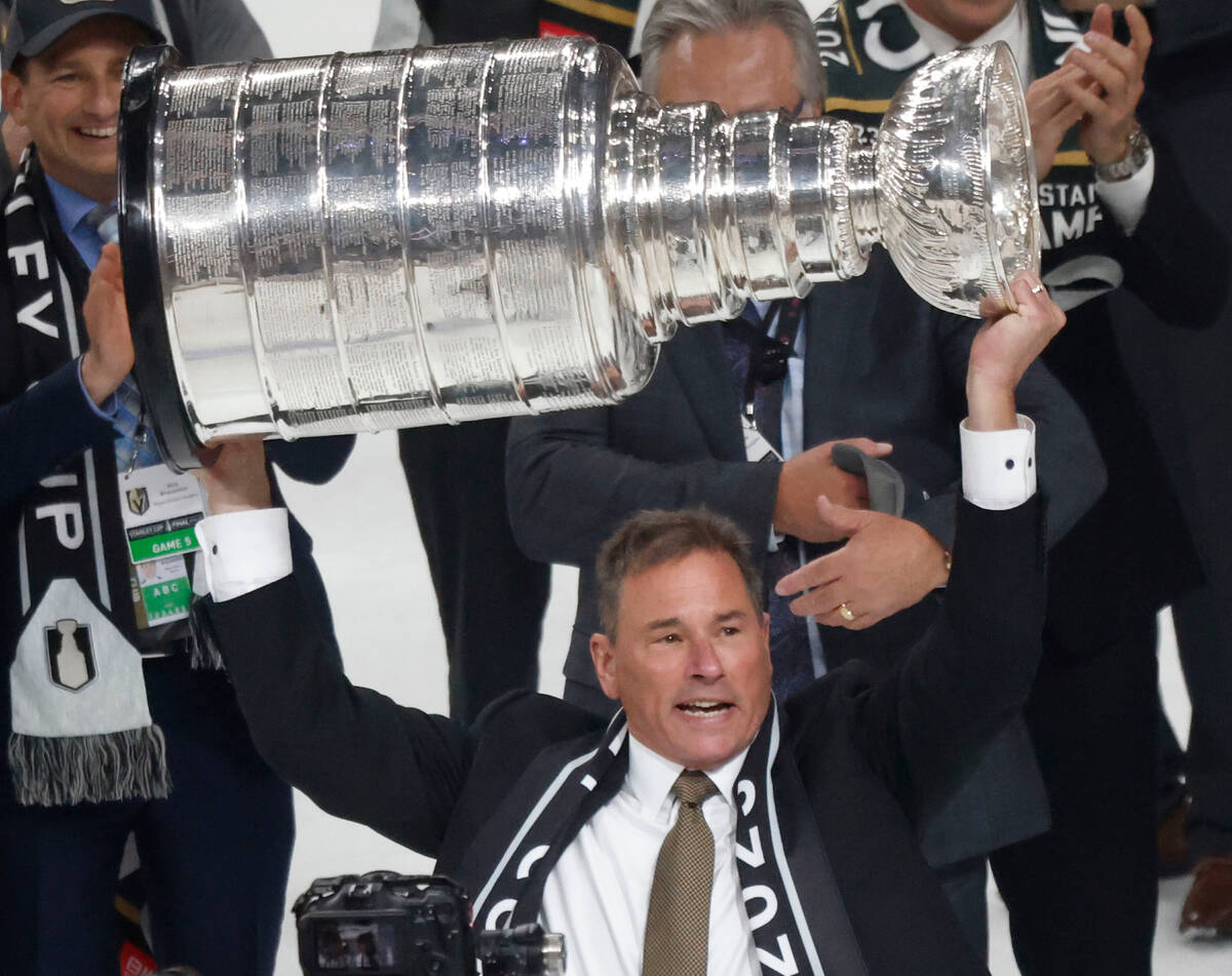 Golden Knights head coach Bruce Cassidy hoists the Stanley Cup after Golden Knights beat Florid ...