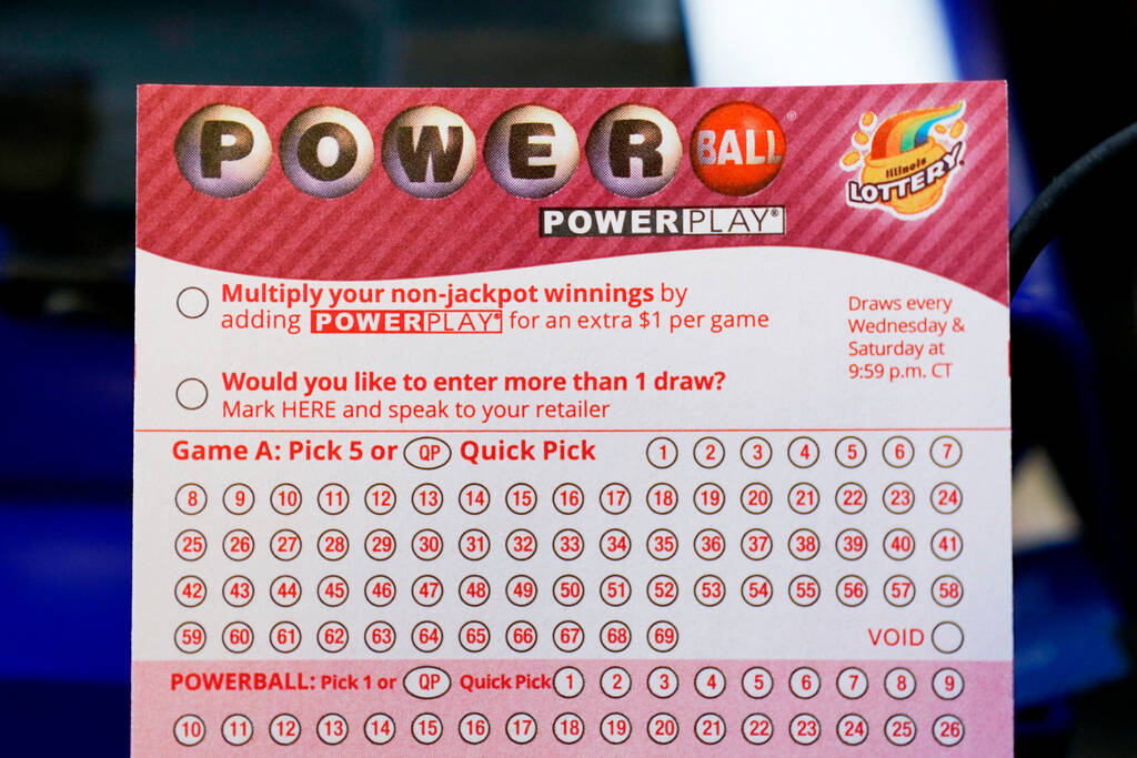 A Powerball lottery ticket is seen at a convenience store in Northbrook, Ill., Tuesday, Oct. 25 ...