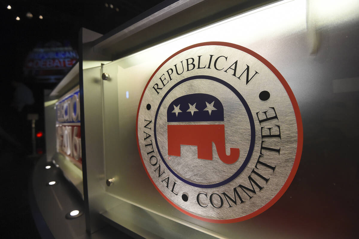 The Republican National Committee logo is shown on the stage as crew members work at the North ...