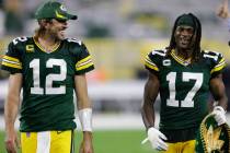 Green Bay Packers' Aaron Rodgers and Davante Adams smile as they walk off the field after an NF ...