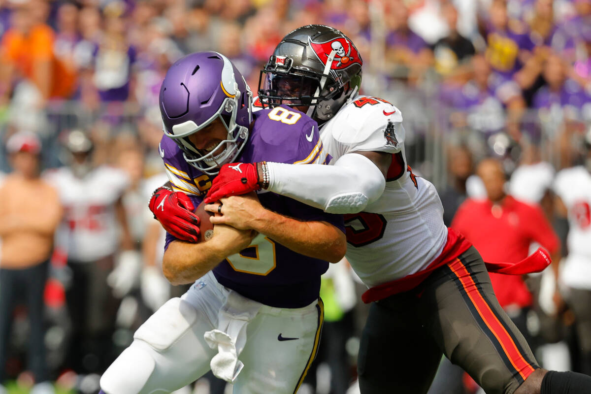 Minnesota Vikings quarterback Kirk Cousins (8) is tackled by Tampa Bay Buccaneers linebacker De ...