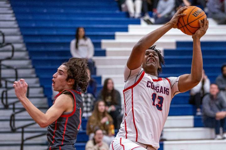 Coronado's Tee Bartlett (13) grabs a rebound as Arbor View's Maximus Romero (1) arrives late du ...